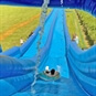 Slip n Slide Water Adventure Devon - Man Sliding Down on Rubber Ring