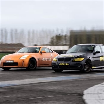 Premium Photo  Car drift battle, two car drifting battle on race track  with smoke, aerial view.